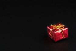 Christmass  tmass gift in red paper isolated at black background