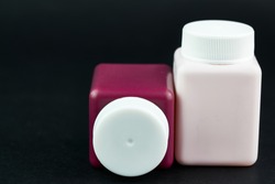Groupe of cosmetic bottles at black background