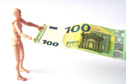 Dummy holding 100 euro banknote. Money or business concept. Abstract conceptual image