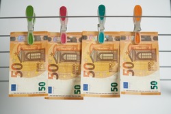 Money laundering on clothesline isolated on white background.