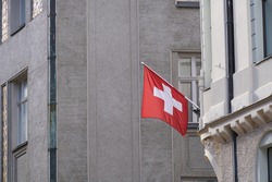 Swiss Flag hanging from Building Facade.