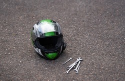 Motorcycle helmet at ground and some wrenches. Wrench at ground