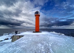 Winter on shore of the Baltic Sea. Lighthouse in ice