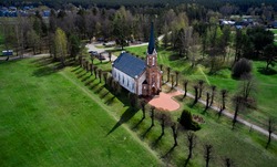 Beautiful white Catholic Church in Latvia ,Aglona, nice blue sky and white clouds. Green grass and trees.