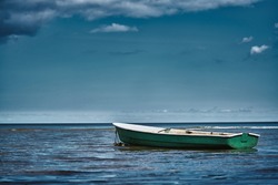 Fishing boat floating on the water, blue sea and sky with copy space