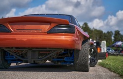 Power drifting car from side. back view