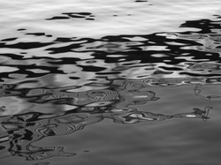 Water reflex background. Abstract reflection and abstract inspection elements in water. City elements distorted in the river. Rippled water texture. Black and white water surface. Layout, template.