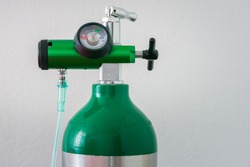 Detail of an oxygen pressure gauge and cylinder with white background