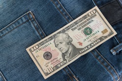 Ten American dollars bill sticking out of the blue jeans pocket,Pocket in old jeans jacket with ten US dollar,Business concept exchange