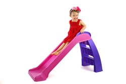 Little girl having fun on slide isolated on white