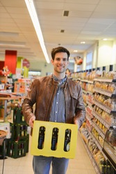 Man holding crate of beer in an organic grocery store