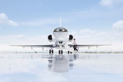 A wide shot of pilot boarding a private jet on a runway.