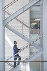 Businessman ascending stairs in an office