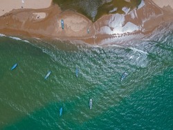 drone shot aerial view top angle bright sunny day beautiful seascape coastal area beaches turquoise blue water tourism destination India tamilnadu road boats waves 