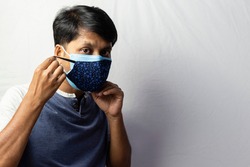 An Indian man shows double masking during covid-19 pandemic, healthcare concept