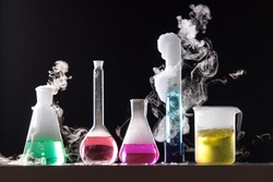 Glass in a chemical laboratory filled with colored liquid during the reaction 