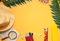 Summer background. Travel accessories, bright glasses, hat, sunscreen, bank cards, smartphone, tropical leaves. Travel and vacation concept at sea with layout for text. Flat lay. top view. copy space