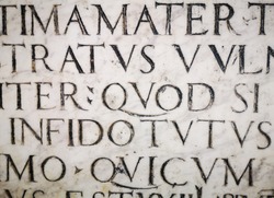 Texture of letters. Roman font. Carving on marble. Lettering background.