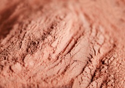 Red bentonite clay powder. Natural beauty treatment and spa. Clay texture close up, selective focus.