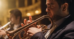 Cinematic Closeup of a Male Trumpet Player Reading a Music Sheet and Playing his Instrument. Professional Musician Rehearsing Before the Start of a Big Jazz Show with his Symphony Orchestra on Stage