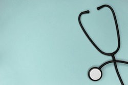 Stethoscope attributes medical,health care ,cardiac care on above turquoise background copy space top view