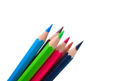 Six different colored wood pencil crayons gathered together on a white paper background