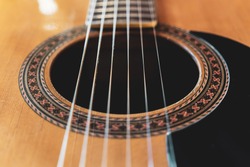 Closeup detail of classical guitar with nylon strings.