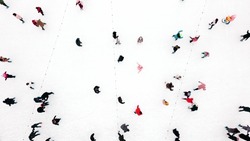 People Skating on an Open-Air Ice Skating Rink. Top View. Many People Skating on Ice of Rink. Aerial Drone View. Beautiful Skating Sport and Winter Outdoor Activities Background