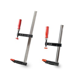 
Clamp.Red and black clamp.Iron clamps.Clamps and vise close-up.The reliable tool for performance of assembly, joiner's and metalwork works.F-shaped design.Tool in the workshop.Engineering tool