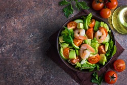 salad with avocado and shrimps in bowl, top view, copy space