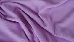Spandex jersey knit fabric texture with elegance and drapery textile patterns in soft purple color. Luxury and beautiful fabric material.