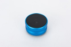 Modern Bluetooth speaker, mini Bluetooth speaker. Blue red black wireless portable Bluetooth speaker, leather background isolation
