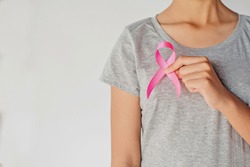 womaen hand holding pink ribbon breast cancer awareness. concept healthcare and medicine