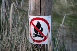 No camp fire sign. Sign which shows its prohibited to make a fire here. Bush fire season - no open flame out doors. No fire on the beach. Light cold colors - clear sign. High resolution image