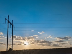 Urban background. Sunset blue sky. Electric generators transmissions watt tower.