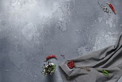 Empty gray stone background with textile and ingredients. Food background in rustic style. Cement table with kitchen towel and spices. Aesthetic minimal background