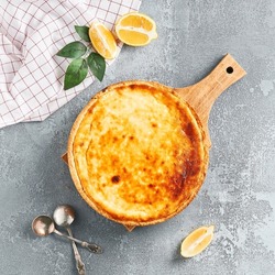 Sweet bakery - cottage cheese pie on gray stone background. Baked cheesecake in rustic style on stone table. Aesthetic composition with cottage pie. Cottage cheese  tart