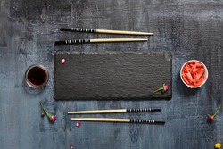 Black Slate Plate with Chopstick on Dark Background. Flat Lay. Food Concept
