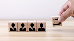 Customer retention concept. Inbound marketing strategy. Attracting potential customers. Hand puts wooden cubes with magnet attracts customer icons on beautiful grey background and copy space.