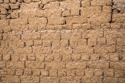 Mud brick wall close up texture background, mixture with clay, soil and straw