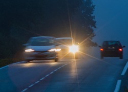 Car with incorrectly adjusted headlights starts to overtake motion blur