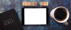 Join Us in Block Letters on a Wooden Table with a Bible and Tablet
