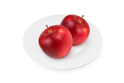 Apples on a white plate on an isolated white background.
