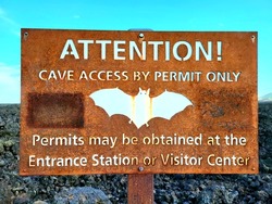 ATTENTION! Cave Access By Permit Only Permits May Be Obtained at Entrance Station or Visitor Center Sign at Craters of the Moon National Monument 