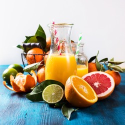 Citrus vitamin juice, healthy drink with fresh fruits, lime, grapefruit, orange, tangerine. Refreshing homemade lemonade. Breakfast beverage
