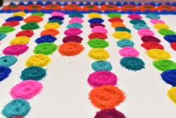 variety of rangoli colors in circle on laminated floor lined up one by one