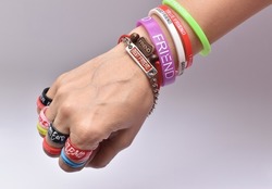 Hand full of friendship bands and ring on the occasion of friendship day with white background