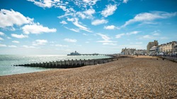 Eastbourne Seafront and Pier, East Sussex, England. A summer view of the seafront of the English south coast seaside town with its landmark pier.