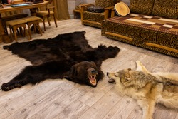 bear and wolf skins on the floor in the hunter's room