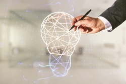 Male hand with pen draws abstract virtual light bulb illustration on blurred office background, future technology concept. Multiexposure